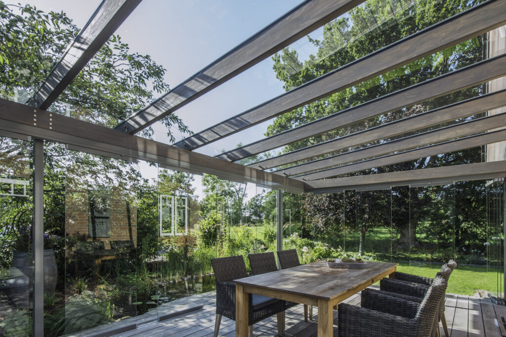 Glashaus, Möbel und Holzboden - alles perfekt aufeinander abgestimmt.